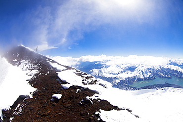 Brody Leven hikes a narrow peak through the clouds. Lakes District, Chile.