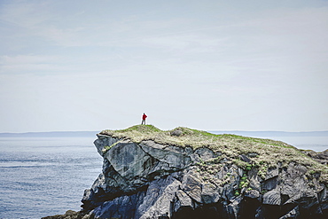 Man of cliff edge overlooking Bay of Fundy Atlantic Ocean from Campobello Island New Brunswick