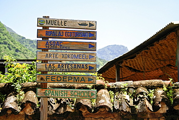 Directional sign pointing to various points of interest in a remote town in Guatemala