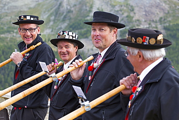 Four traditionally dressed locals with alphorns, Zermatt, Valais, Switzerland