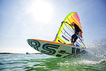 Pierre Le Coq performing a jibe with his windsurf board at Plouguerneau, Brittany, France.