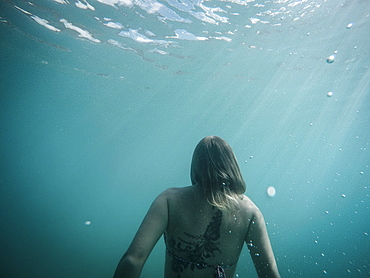 Woman swimming underwater, St. John, US Virgin Islands, USA