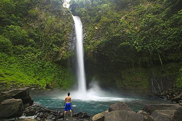 A hiker stands at the base of La Fortuna Waterfall in the Alajuela Province of Costa Rica.