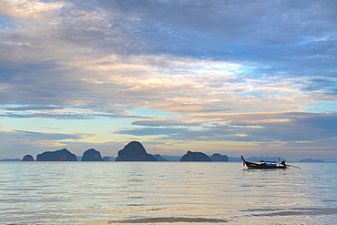 View of long tail boat floating on Adaman Sea at sunrise, Krabi, Krabi Province, Thailand