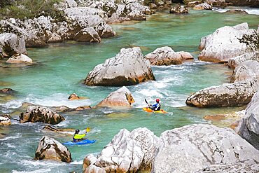 Male kayakers on green colored Soca river near Bovec, Slovenia