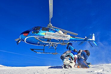 Skiers doing heliskiing in Formazza Valley, Piedmont, Italy