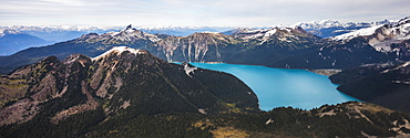 Garibaldi Lake in British Columbia, Canada. An turquoise colored alpine lake that is surrounded almost entirely by mountains. Iconic Black Tusk, the remains of a strato volcano can be seen in the background.