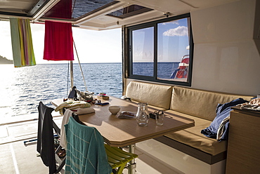 View of table, seats and chairs on deck of catamaran