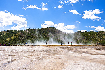 Scenic view of Midway Geyser Basin with tourists in the distance, Yellowstone National Park, Wyoming, USA