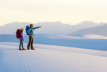 Side view of woman and girl hiking in White Sands National Monument, Alamogordo, New Mexico, USA