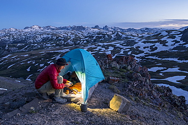 A man camping with a tent above Stony Pass near the Grenadiers and the Weminuche Wilderness, Silverton, Colorado, USA