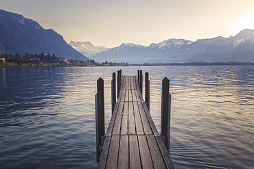 View of jetty on shore of Lake Geneva at sunset, Switzerland