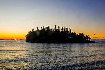 Beautiful scenery with silhouette of island with trees at sunset, Two Harbors, Minnesota, USA