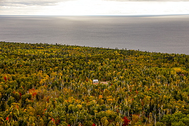 Scenic view of forest with log cabin and sea, Oberg Mountain hiking trail, Tofte, Minnesota, USA