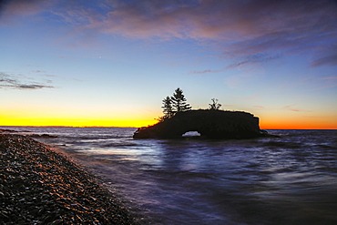 View of rock formation called Hollow Rock at sunset, Lake Superior, Grand Portage, Minnesota, USA