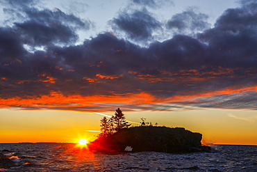 View of rock formation called Hollow Rock at sunset, Lake Superior, Grand Portage, Minnesota, USA