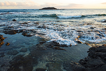 Sunset views with rocks and water from Halape Beach along the Puna Coast Trail in Hawaii Volcanoes National Park on the Big Island of Hawaii