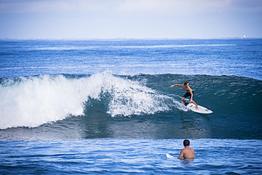 Full length shot of young man surfing in sea