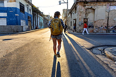 Rear view of female tourist walking in street of Havana, Cuba