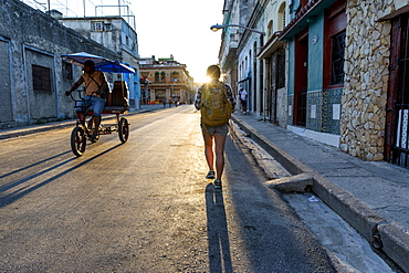 Rear view of female tourist walking in street of Havana, Cuba