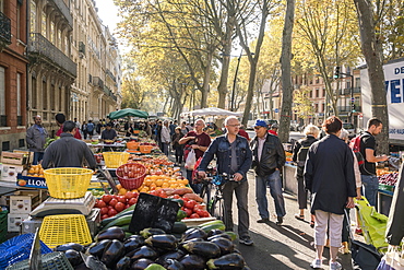 Crowded food street market and part of tenement house, Toulouse, Occitanie, France