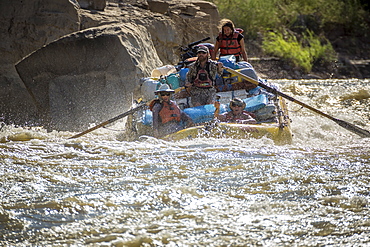 Men and women rafting on rushing Green River in Desolation Canyon, Utah, USA