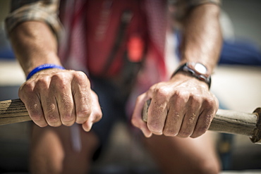 Close-up of mans hands gripping oars of inflatable raft, Desolation/Gray Canyon section, Utah, USA