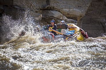 Men and women rafting on rushing Green River in Desolation Canyon, Utah, USA