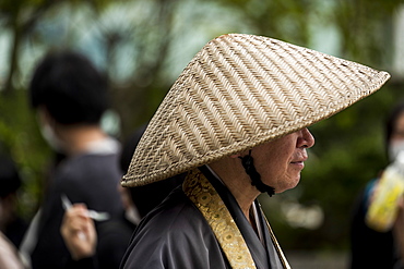 Profile of senior man wearing traditional conical hat, Tokyo, Tokyo, Japan