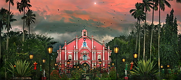 Building exterior of colonial style church among palm trees at Villa Escudero Plantation, Laguna, Luzon Island, Philippines