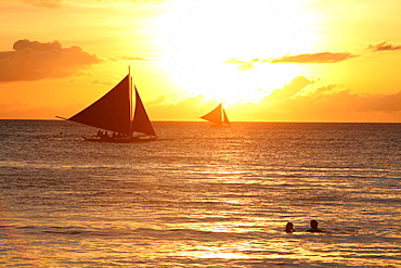 Tranquil scene with sailboats in sea at sunset, Boracay, Aklan, Philippines