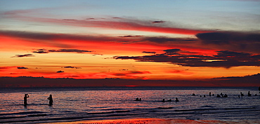 Silhouettes of tourists swimming in sea at sunset, Boracay, Aklan, Philippines