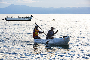 Fisherman in a traditional dug out canoe at Cape Maclear, on Lake Malawi, Malawi, Africa.