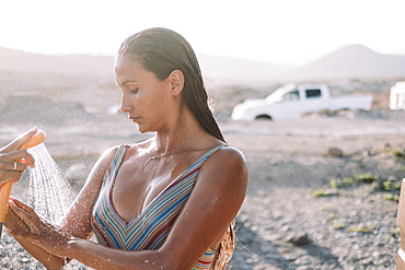 Woman takes shower outdoors, Tenerife, Canary Islands, Spain