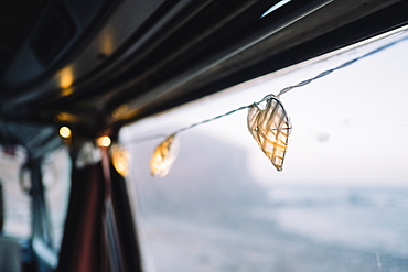 Lit string lights hang from camper van door, Tenerife, Canary Islands, Spain