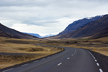 Empty Ring Road highway winding across mountain valley, Hringvegur, Iceland