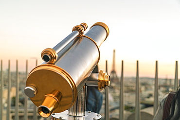 Viewing telescope against clear sky at sunset on Triumphal Arch, Paris, France