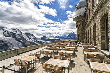 Tables and chairs on terrace of weather station on top ofÂ GornegratÂ summit, Â Zermatt, Valais, Switzerland