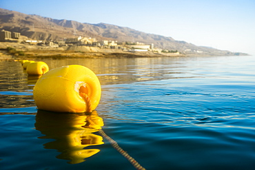 Close-up of single yellow buoy floating on Dead Sea, Madaba Governorate, Jordan