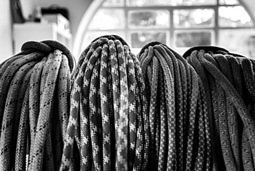 Black and white picture of climbing ropes hanging on climbers bedroom, Cascais, Lisbon, Portugal