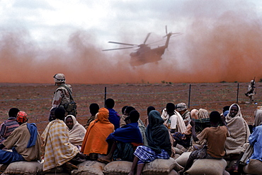 Food is airlifted by a helicopter to a food distribution site, Somalia.