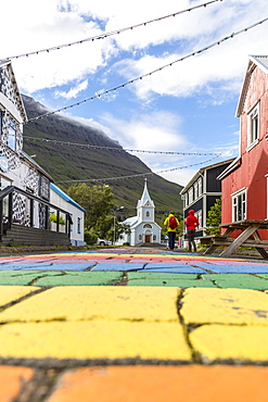 The main walking street of Seydisfjordur is painted in bright colors of the rainbow, Iceland