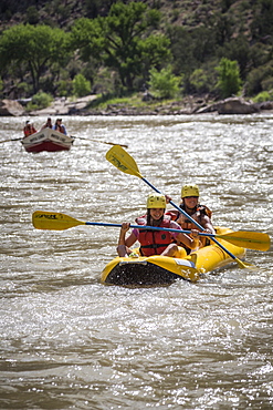 A young girl and her mother paddling an inflatable kayak, Green river rafting trip, Desolation/Gray Canyon section, Utah, USA