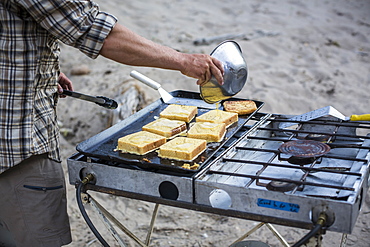 French toast getting made in an outdoor kitchen during a Green river rafting trip, Desolation/Gray Canyon section, Utah.