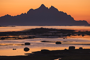 Scenic landscape with silhouette of Vogakallen mountain peak at sunset, Lofoten Islands, Norway