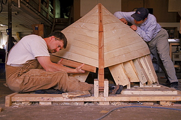 Students at the Landing School construct the hull of a small peapod design boat in Arundel, Maine.