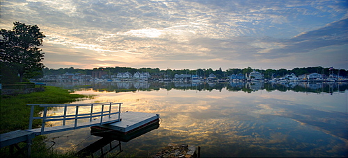 Morning clouds reflect in Rowayton Harbor as the sun just crests the horizon. Rowayton, a waterfront community of Norwalk, CT, is home to many sailors and fishermen and is about 45 miles up Long Island Sound from New York City.