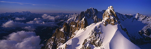 Panoramic of high mountain peaks in the Alps.