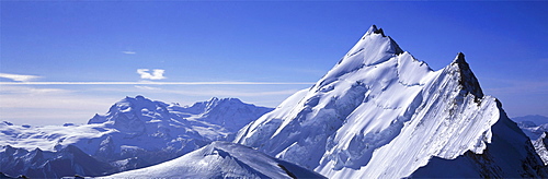 Panoramic of high mountain peaks in the Alps.