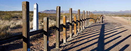 The new post & rail border fence runs next to the original border markers, Arizona.